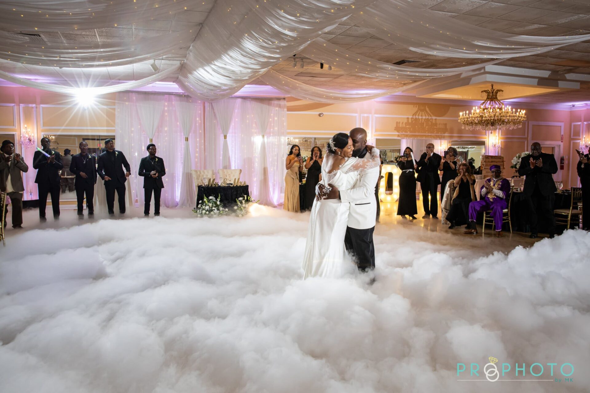 Bride and groom enjoy their first dance while walking on clouds at their luxury all inclusive wedding venue near New Jersey